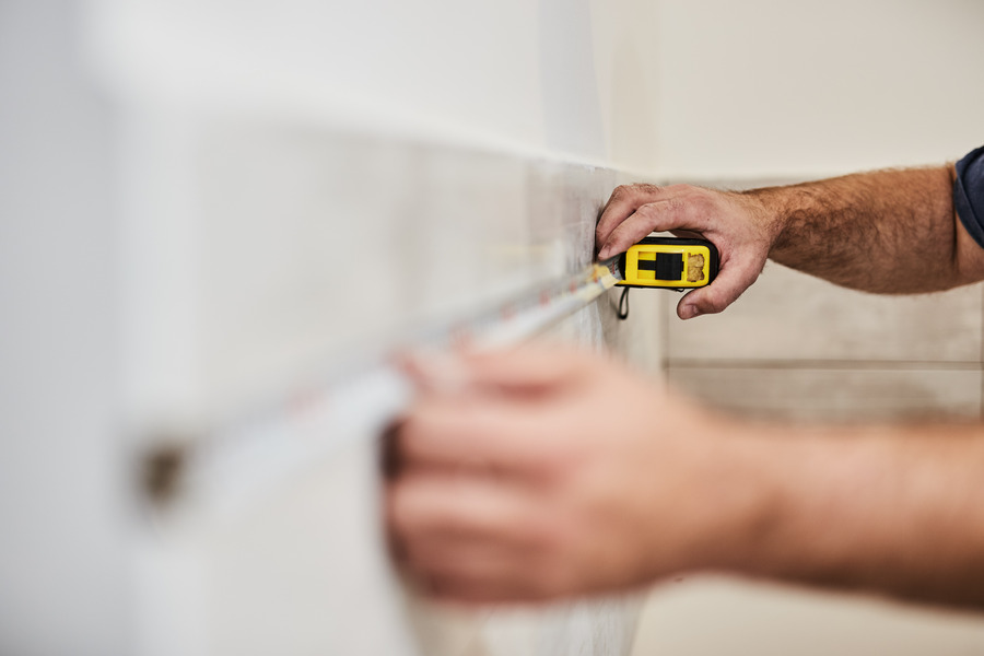 Measuring wall perimeter before skirting board installation