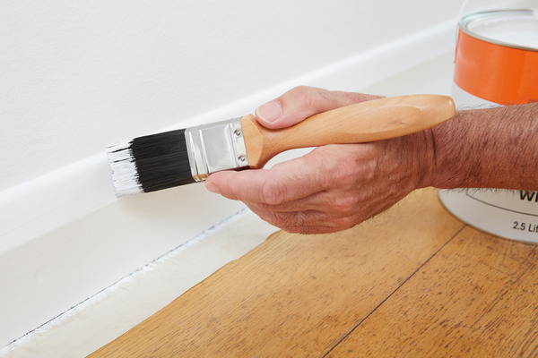 Photograph showing how to load a synthetic brush with gloss paint