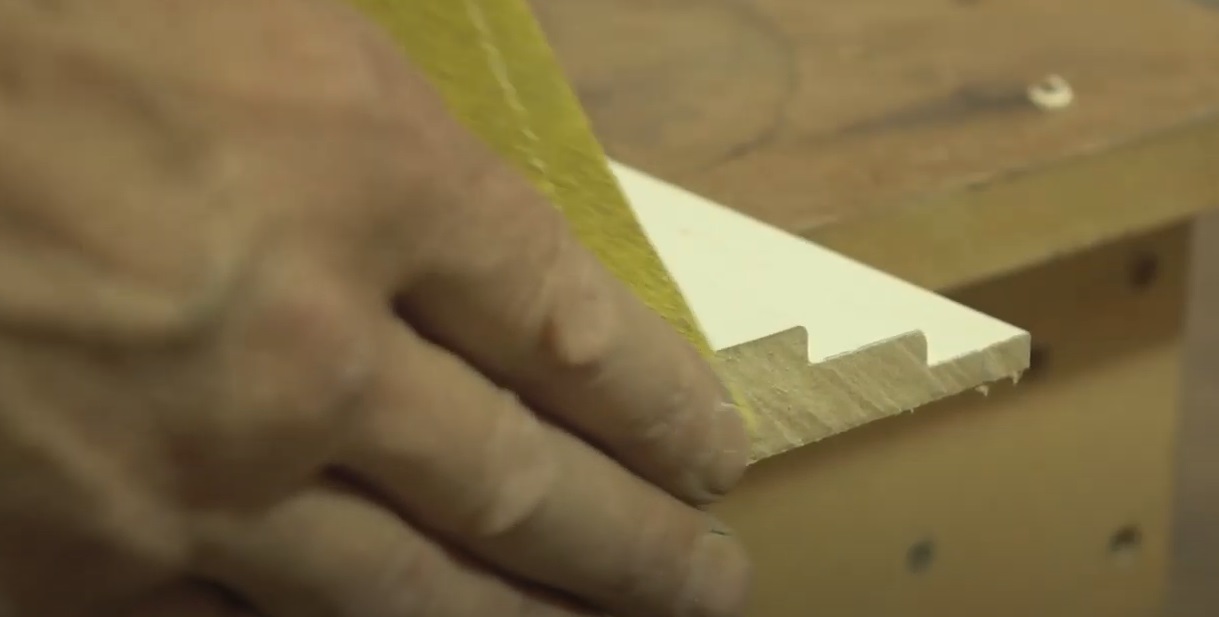 Sanding the edge of a skirting board