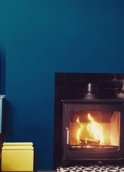 Traditional fireplace with a blue wall
