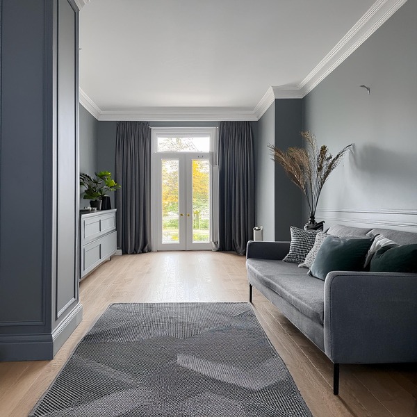 Sophisticated lounge with floor-to-ceiling grey panelled skirting, perfect for a grand statement.