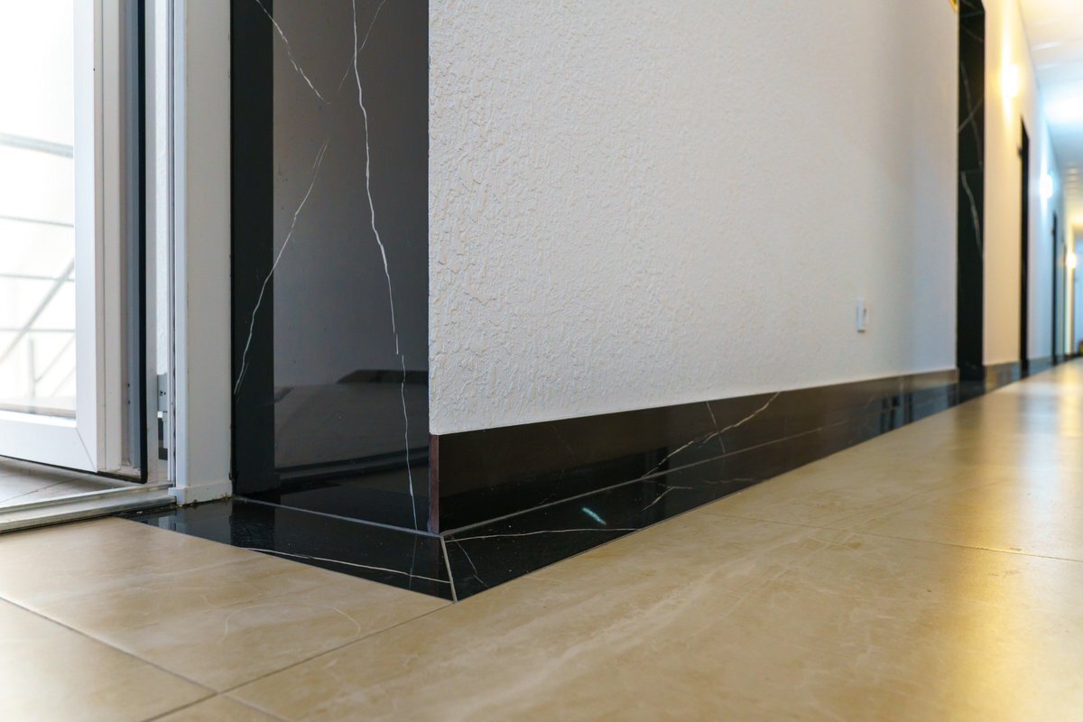 Tiled skirting alternative with floor-to-wall tile upstand design