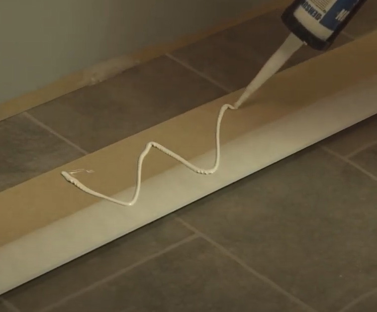 Applying Adhesive To The Back Of A Skirting Board